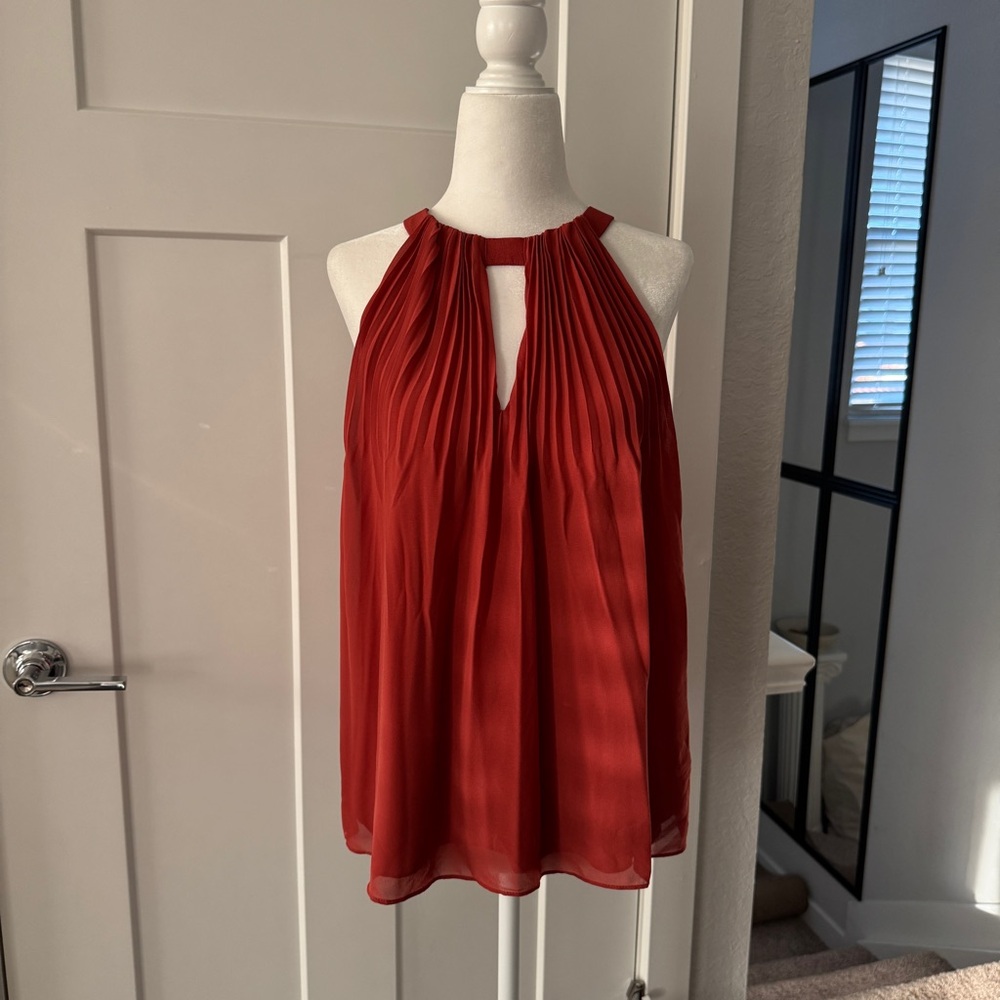 Bebe burnt orange pleated halter top with cutout detail.